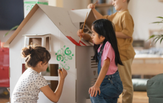 children painting playhouse